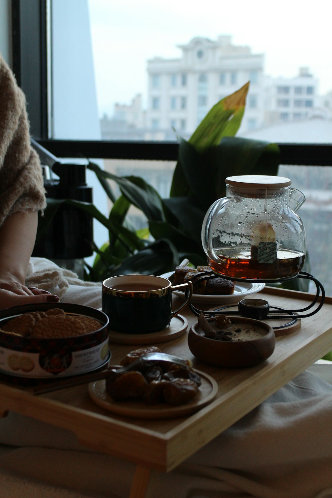 a-woman-sitting-at-a-table-with-a-tray-of-food-5ql2l8xyll8